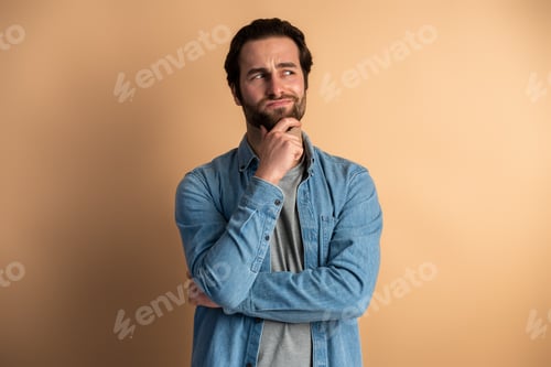 Preview: Doubtful bearded man contemplating, pondering difficult question, trying to make right choice