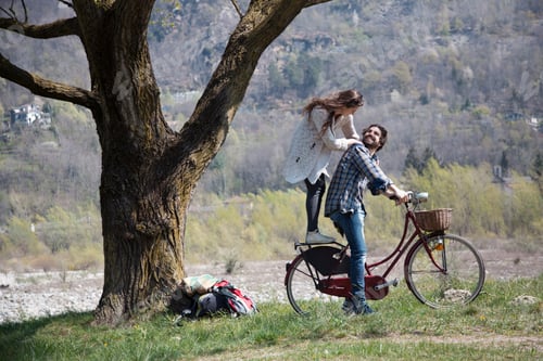 Preview: Couple enjoying a romantic moment on a bike ride in the countryside.
