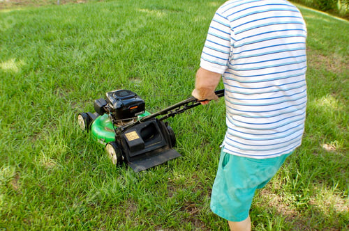 Preview: Man cutting grass with lawnmower