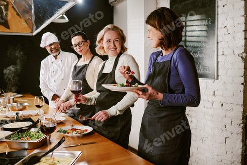 Preview: Middle Aged Caucasian Women Enjoying Meal Tasting Experience during Cooking Class