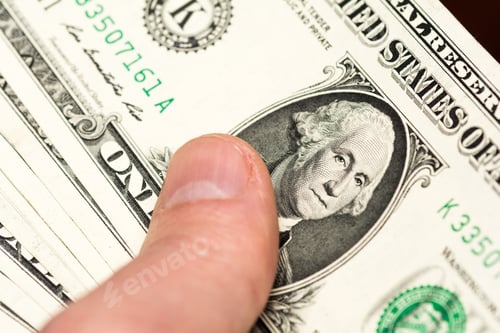 Preview: Hand holding a bunch of US dollar banknotes