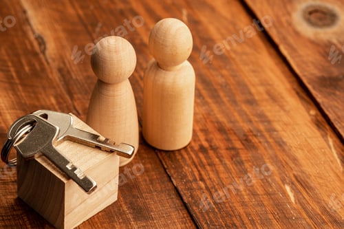 Preview: Real estate concept with toy wooden figures and house key
