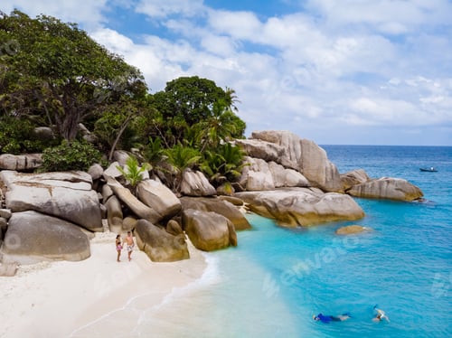 Preview: Young couple on a white tropical beach with palm trees Coco Island Tropical Seychelles Islands