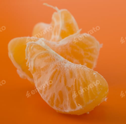 Preview: Peeled tangerine segments isolated on orange background