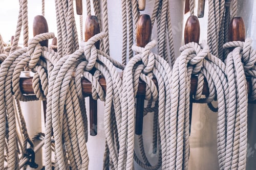 Preview: Ship ropes tied to the mast before lowering sails.