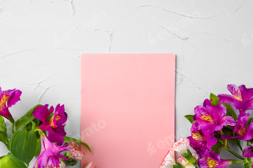 Preview: Top view of a pink paper letter and flowers with copy space