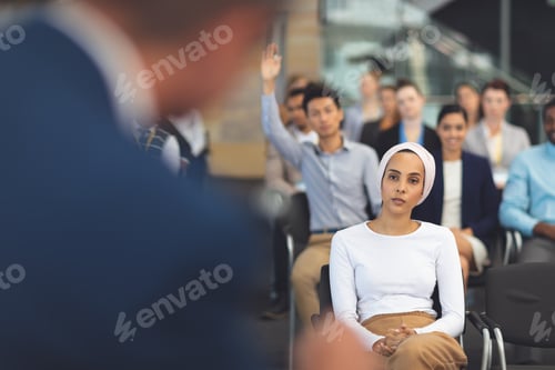 Preview: Business people listening to businessman speak at business seminar