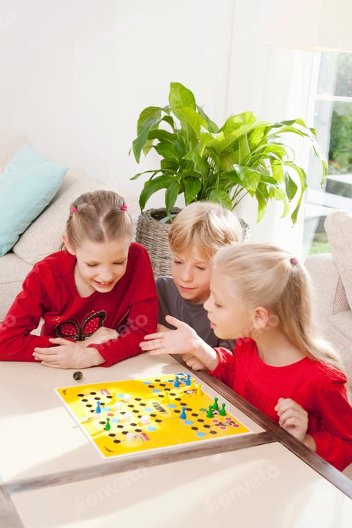 Preview: Three children playing a board game