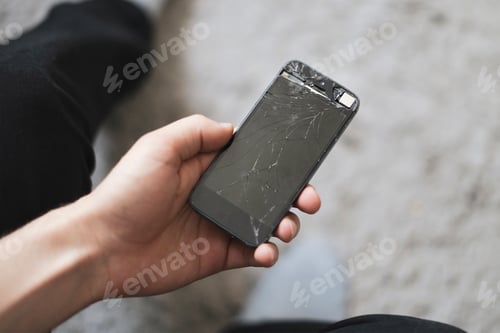 Preview: the person holding crashed smartphone, broken screen of mobile phone