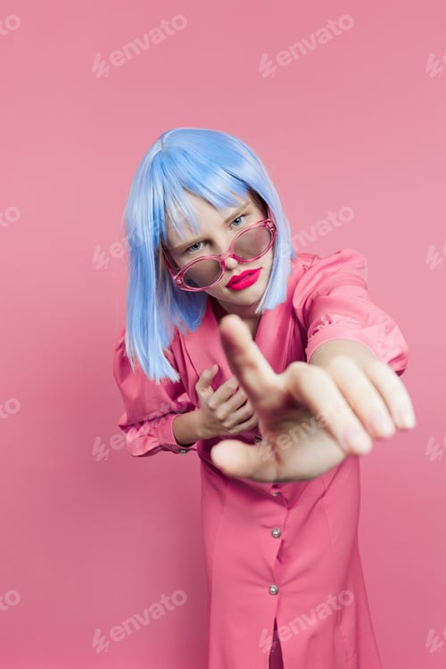 Preview: pretty woman in sunglasses wears a blue wig makeup isolated background