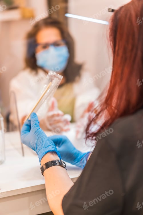 Preview: A client with a face mask receiving a treatment. Covid-19