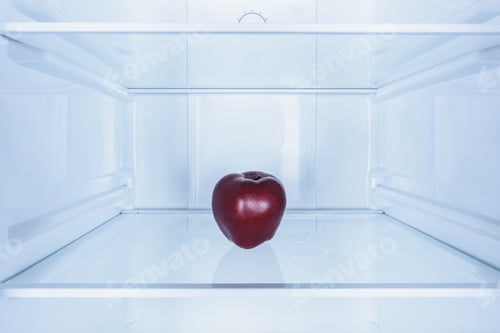 Preview: one burgundy apple on shelf in fridge