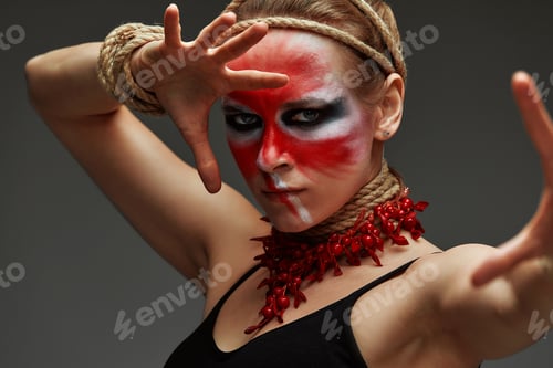 Preview: close up portrait of young beautiful girl with colorful face painting. Halloween professional makeup