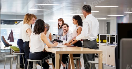 Preview: Business group brainstorming in open plan office, close up