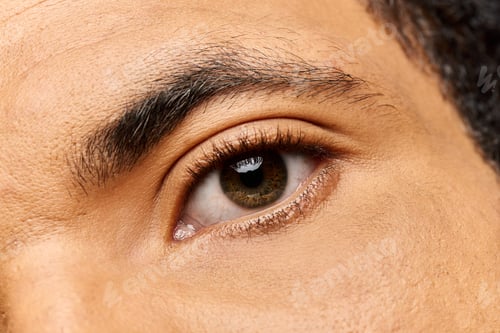 Preview: Captivating glance of a handsome man showcasing expressive eyes amid soft lighting