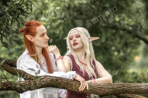 Preview: An elf man and an elf woman are standing near a tree. A pair of stunning detailed elven fantasies