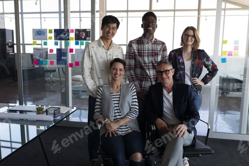 Preview: Portrait of mixed race business people posing together in modern office. They seem happy
