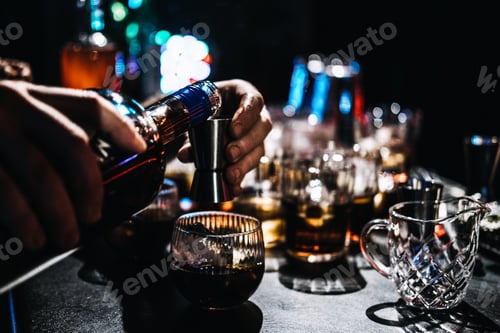 Preview: Bartender Mixing a Cocktail with Coffee Liqueur at a Busy Bar