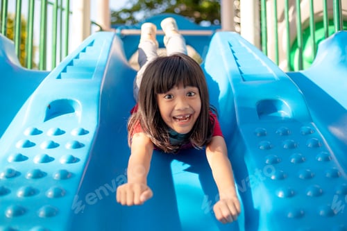 Preview: Cute little girl having fun on a playground outdoors in summer
