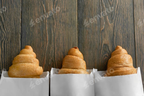 Preview: Freshly baked croissants on wooden table