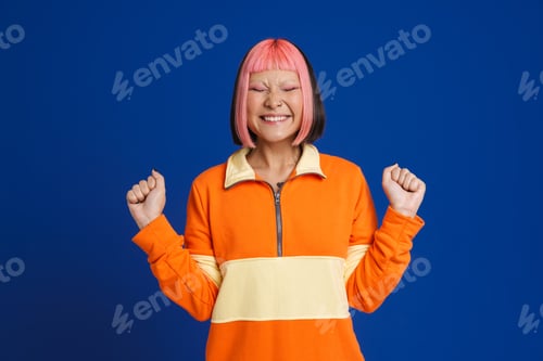 Preview: Asian girl laughing while posing with clenched fists