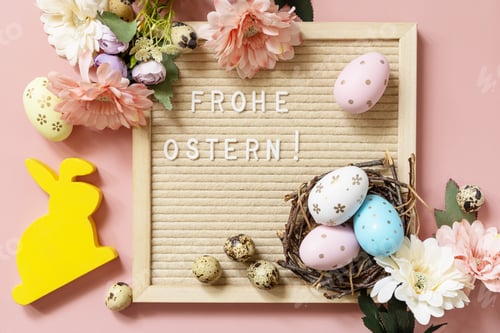 Preview: Letter board, colorful eggs and green branches on a pink background.
