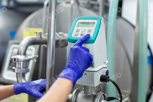 Preview: Automated milk production process at the factory. The worker starts the machine.