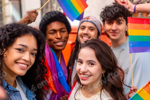 Preview: Young activists holding rainbow flags celebrating pride month