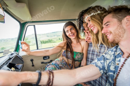 Preview: Happy friends driving a vintage minivan