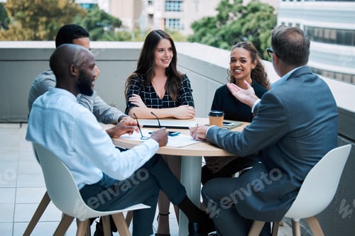 Preview: Shot of a group of businesspeople having a meeting together on the balcony of an office