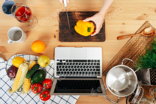Preview: Unrecognizable woman cooking vegetables in her kitchen