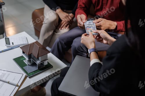 Preview: Real estate agent handing money to clients after property dealing