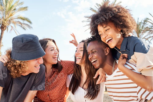 Preview: Group of young people of different races laughing and having fun outdoors.