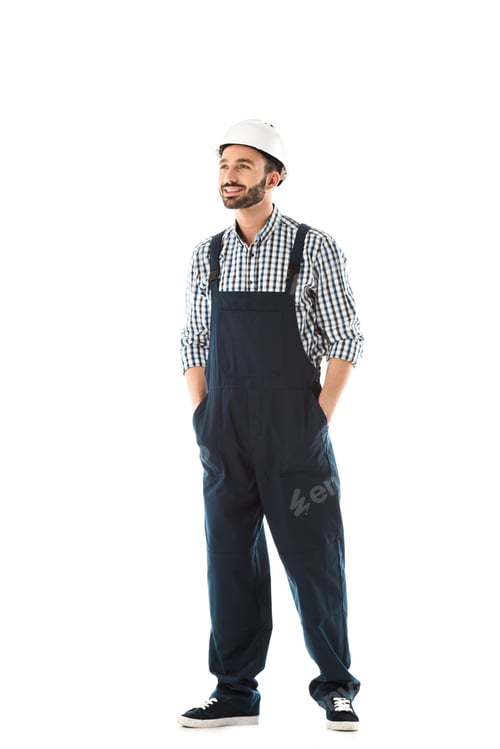 Preview: handsome smiling construction worker with hands in pockets looking up isolated on white