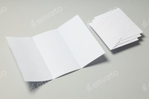 Preview: Blank white sheet and envelopes on light gray background