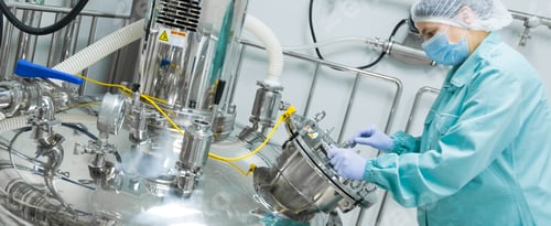 Preview: Pharmaceutical factory woman worker in protective clothing operating production line in sterile