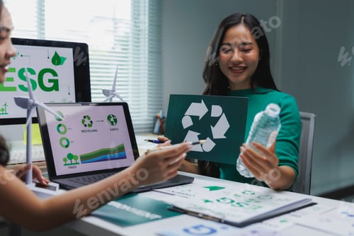 Preview: Businesswomen discussing recycling and esg policies in modern office