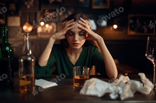 Preview: Drunk depressed woman at the counter in bar