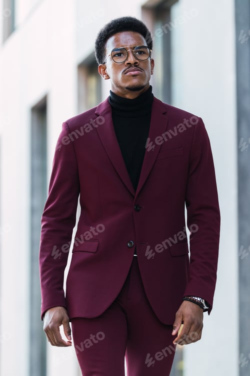 Preview: Serious young handsome man walking on street