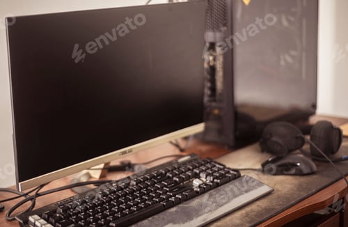 Preview: Desktop computer workstation close-up photo. keyboard mice and headset on the table top