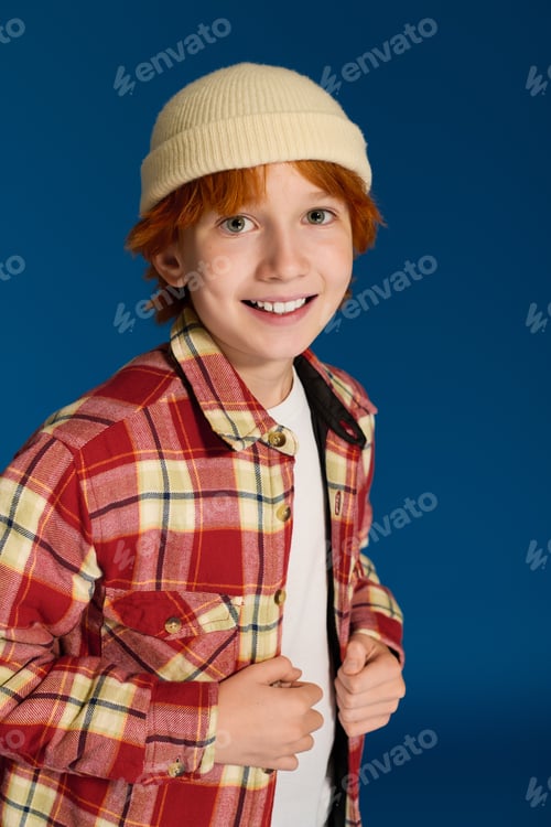 Preview: Redhead boy shows off stylish casual look in vibrant studio setting