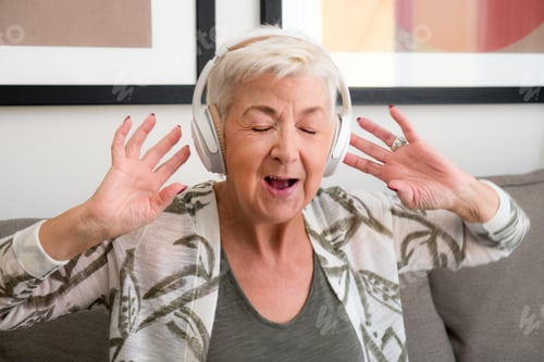 Preview: Senior adult woman singing along wearing her headphones