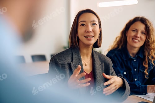 Preview: Korean businesswoman communicating with colleagues on a meeting in the office.
