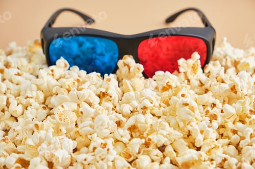 Preview: top view of 3d glasses on crunchy popcorn, cinema concept