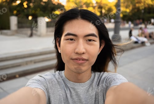 Preview: Selfie of young handsome chinese tourist male with confident expression while visiting Madrid city.
