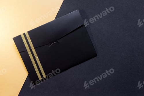 Preview: black envelope mockup, Flat Lay, on black and gold background with copy space.