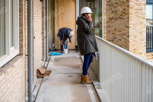 Preview: Female Construction manager walking around site on the phone