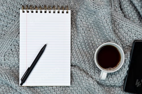 Preview: Cosy working writing place, sweater coffee, note pad. phone. Warm concept in cold weather.