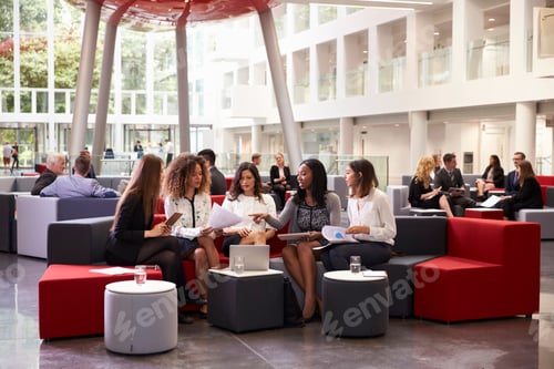 Preview: Businesswomen Meeting In Busy Lobby Of Modern Office