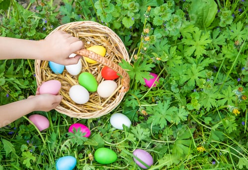 Preview: Krashenki homemade eggs in the basket and the hands of a child. Selective focus.